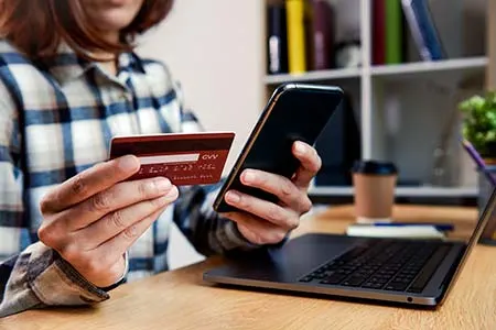 Woman making an online payment using a credit card